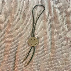 Smiley face bolo tie.